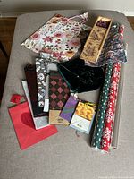 Overview of gift bags, wrapping paper rolls, and wine gift box spread on a surface