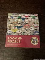 Front of puzzle box showing tea cup pattern and branding