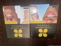 Front covers of Living Language Complete Edition Spanish and French language learning books, featuring images of faces and brand logos.