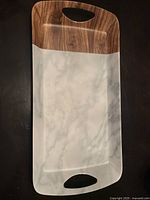 Top view of rectangular platter showing marble and wood grain pattern with integrated handles on both ends.