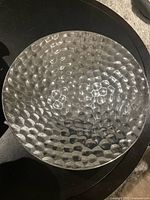 Top view highlighting the pebble textured pattern on the bowl surface showing uneven, hammered dimpled metal texture.