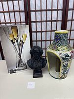Set includes six champagne flutes in original box, Shakespeare bust statue, and colorful fluted candle holder with floral design.
