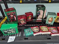 Photo displaying multiple Christmas ornaments in original boxes including carousel horse and other holiday themed ornaments