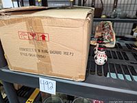 Box labeled for Yankee Candle gingerbread house wall hangings, confirming part of lot contents