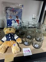 Full lot front view showing all glasses, plush, and program.