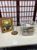 Photo of a wooden 8x10 picture frame, a clear glass display globe with wooden base, and a plastic container filled with Cats Meow wooden village pieces.