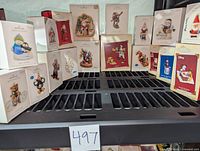 Image showing assorted Hallmark Keepsake ornament boxes arranged on a shelf, various designs visible including Disney characters, snowmen, and holiday figures.