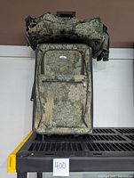 Single upright suitcase and travel tote bag stacked on top, showing front zippers and floral leafy pattern