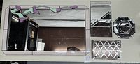 Seven items shown: one stained glass mirror with floral design, two rectangular mirrors, two octagonal mirrors, one monogrammed coaster, one rectangular mirrored tray with feet