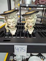 Two vintage ladies head vases placed side by side, showing full front view with hats and pearl necklaces.