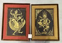 Two framed reproductions of Thai temple rubbings in wood and burlap frames.