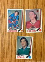 Front view of the three hockey cards featuring players Rod Seiling, Gilles Marotte, and Carol Vadnais.