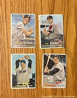 Front view showing all four 1957 Topps baseball cards with player images and names visible.