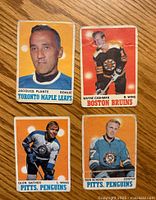 Front view of the four hockey cards showing Jacques Plante (Toronto Maple Leafs), Wayne Cashman (Boston Bruins), Glen Sather (Pittsburgh Penguins), and Ron Schock (Pittsburgh Penguins).