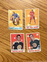 Front side of four hockey cards: Bruce Gamble, Larry Jeffrey, Don Marcotte, Kenny Hodge