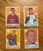 Front side of four 1970-71 O-Pee-Chee hockey cards showing portraits and player details.