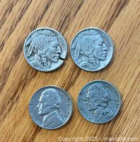 Obverse sides of four US nickels showing 1924 and 1936 Buffalo nickels, 1942 and 1965 Jefferson nickels