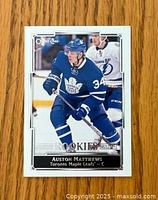 Front of the glossy rookie card showing Auston Matthews in Toronto Maple Leafs uniform.