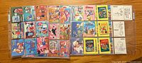 Full spread of the card pages showing rows of colorful Flintstones cards arranged in plastic sleeves.