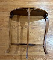 Underside view showing curved legs, central support, and overall table structure.