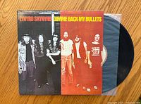Front cover of the Lynyrd Skynyrd 'Gimme Back My Bullets' vinyl album showing band members and title.