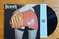 Front cover of Nazareth "The Catch" vinyl record album showing artwork of person in red leather skirt and fishnet stockings holding a baseball glove.