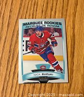 Front side of Nick Suzuki OPC Platinum hockey card showing Marquee Rookies design, player image in Montreal Canadiens uniform, and card branding.