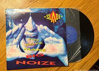 Front of the album cover showing the title and band name with partially visible vinyl record in inner sleeve.