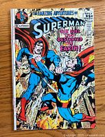Front cover of Superman comic #242 showing the two Superman characters fighting in the city.