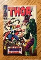 Front cover of The Mighty Thor #146 comic showing Thor fighting a villain in green attire with a top hat. Markings are visible on the cover.