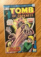 Front cover of Tomb of Darkness #19 Marvel comic book showing a monstrous figure and a frightened boy.