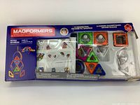 Magformers Basic Set box with colorful geometric magnetic pieces inside, visible in blister packaging.