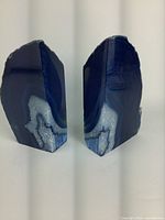 Pair of natural blue agate geode bookends showing polished sides and rough natural edges.