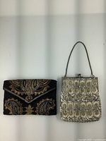Pair of vintage beaded clutch purses side by side, showing overall condition and style.