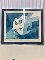 Full front view of framed vintage abstract print with geometric shapes in blue and cream.