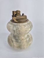 Front and side view of vintage lighter made from solid marble/onyx stone with brass lighter mechanism.