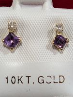 Front view of both earrings showing 10KT gold mark on display card.