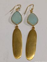 Front view of earrings showing chalcedony stones and oval gold-tone dangles