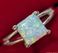 Close-up front view of the silver ring with square opalite stone showing gemstone's iridescent colors and split shank band.