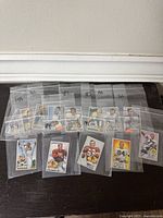 Photo of 15 individual 1951 Bowman football cards, each inside clear plastic bags labeled with numbers.