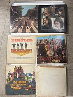 Photo shows six Beatles vinyl albums stacked and laid out for clear view of front covers.