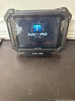 Front view of tablet powered on displaying AutoProPAD logo