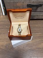 Full view of Bernarde two-tone men's wristwatch with gold and silver tones in a wooden presentation box labeled Bernarde watch company.