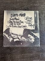 Back cover of Prince Dirty Mind album showing handwritten song titles over a grayscale photo, still sealed in original shrink wrap.