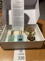 Four skincare products in their original box including two serums and two creams with detailed ingredient sheet inside.