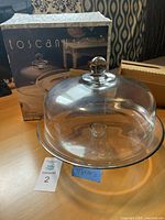 Photo showing the glass cake stand with domed lid and original Toscany box packaging.