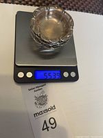 Four vintage sterling silver bowls shown stacked on a digital scale reading about 55.39 grams total weight.