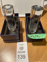 Pair of two Villeroy Boch crystal candleholders shown in foam-fitted original boxes with measurements labeled 5 1/2 inches height and 2 inches diameter.