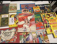 Photo depicting a collection of approximately 15 vintage children's books with colorful, illustrated covers spanning various classic and whimsical themes like circus, animals, fairy tales, and crafts. Books display wear consistent with age.