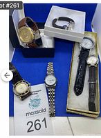 Image showing six women's watches of various styles and bands, arranged on a blue background with boxes and maxsold tag 261.